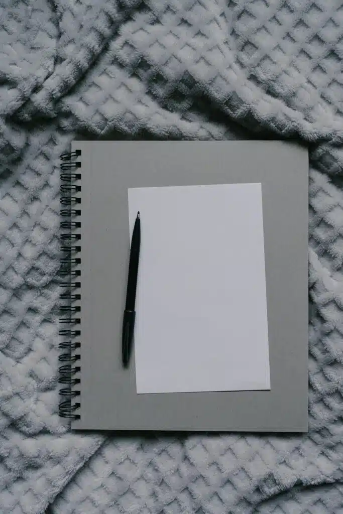 Notebook with paper and a pen.