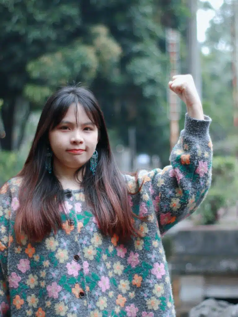 Woman raises fist in the air.